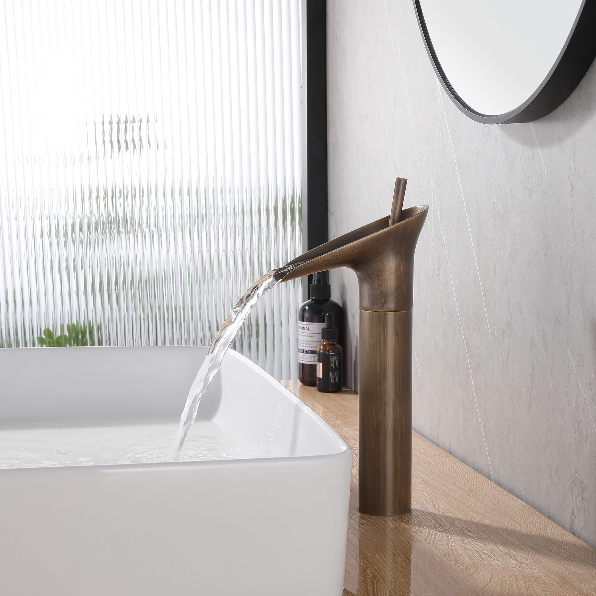 vessel sink faucet with water coming from the waterfall