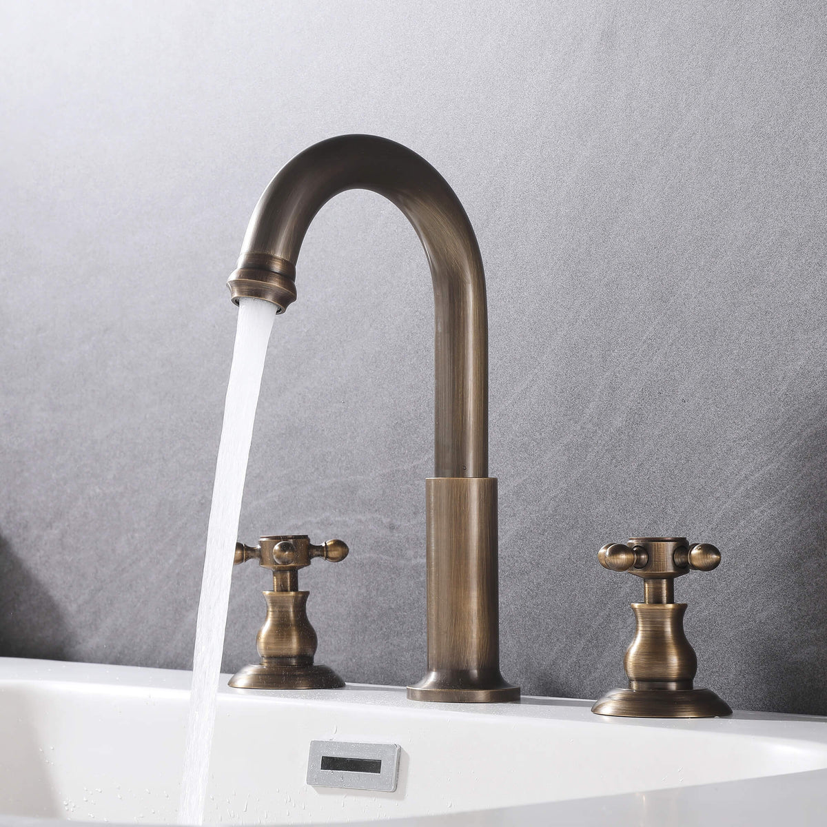 3-hole cross handle bathroom faucet with water flowing into a white sink