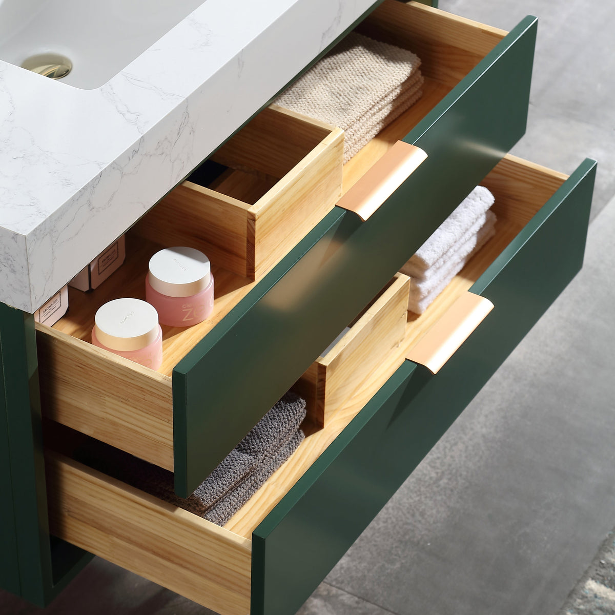 Soft-close wood drawers inside green wall-mounted bathroom vanity