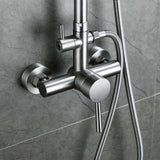 Close-up of brushed nickel shower mixer valve with temperature control and hose attachment