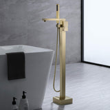 Brushed gold freestanding tub filler faucet next to modern bathtub