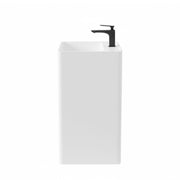 Side view of modern square freestanding pedestal sink in matte white resin stone with black faucet, minimalist bathroom basin design.