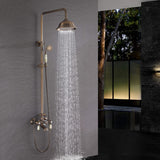 Antique brass overhead rain shower delivering a wide stream of water