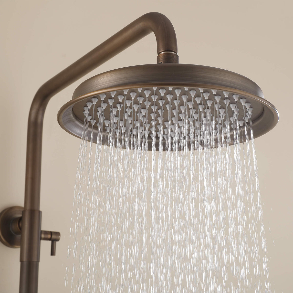 Water flowing from antique brass rainfall shower head