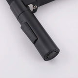 Close-up of black dual-mode faucet sprayer with switch button and aerator nozzle