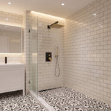 Matte black and brushed gold rainfall shower head providing full body water coverage in modern bathroom