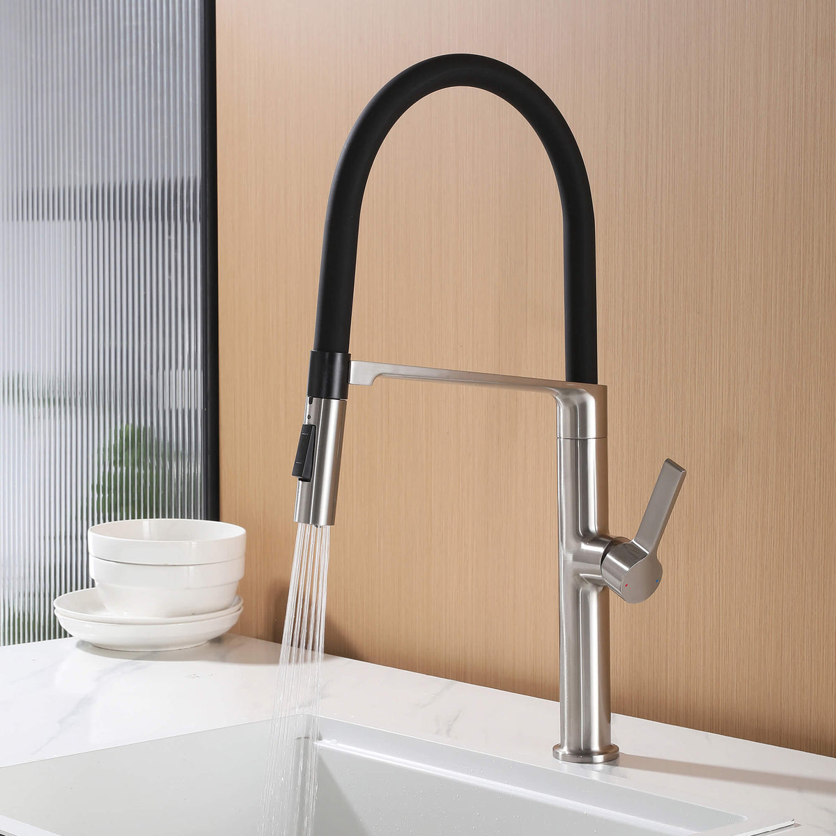 Kitchen faucet with black pull-down hose using spray function for sink rinsing