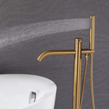 Handheld shower on brushed gold freestanding tub filler delivering a wide rinsing spray