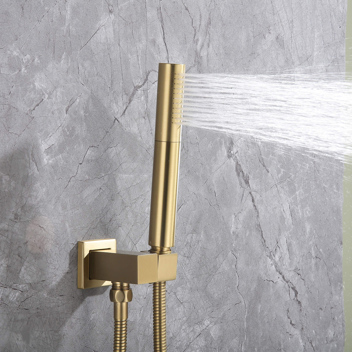 Cylindrical brushed gold handheld shower wand spraying water, part of dual shower system.