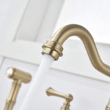 Close-up of brushed gold kitchen faucet spout and aerator with running water