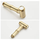 Close-up of brushed gold kitchen faucet side sprayer with spray nozzle and threaded connection