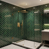 Brushed gold rain shower system installed in modern bathroom with square rainfall shower head and handheld sprayer