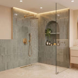 Brushed gold rain shower system in use with 10-inch rainfall shower head and handheld shower