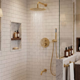 Brushed gold rain shower system with rainfall water flow, handheld shower and bathtub spout in a tiled shower area