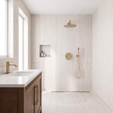 Brushed gold rain shower system with overhead rainfall shower and handheld shower in modern bathroom
