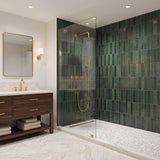 Brushed gold shower system installed in a modern bathroom with rainfall shower head and handheld shower