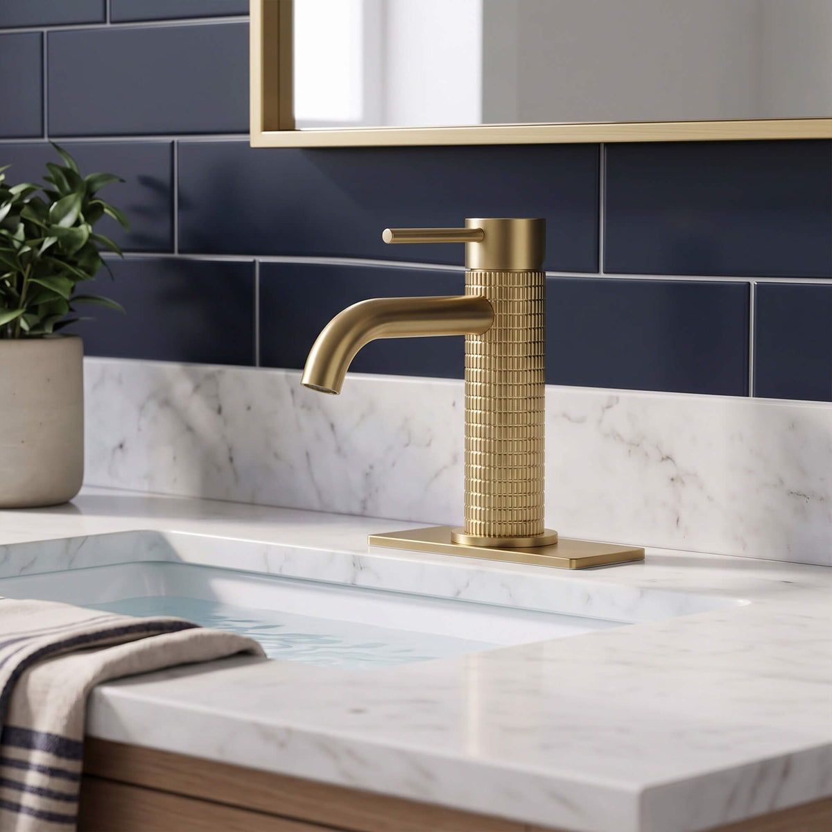 Brushed gold single hole bathroom faucet installed on modern marble vanity sink with elegant design