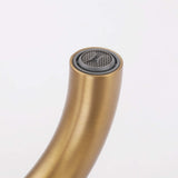 Close-up of brushed gold tub filler spout with built-in aerator