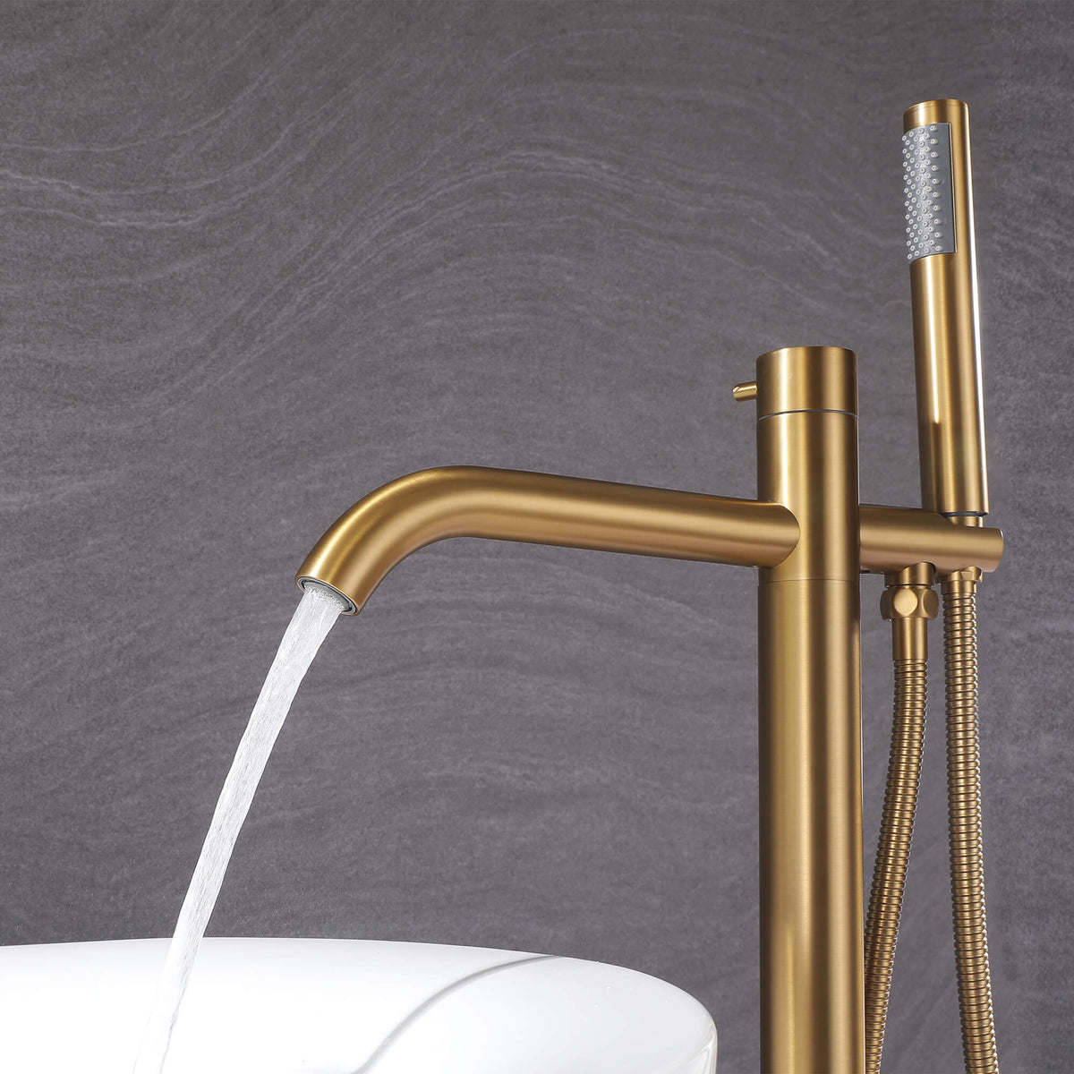 Brushed gold freestanding bathtub faucet with curved tub spout and handheld shower
