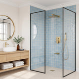Modern walk-in shower with a gold rainfall head, slim hand shower, concealed controls and waterfall tub spout in use