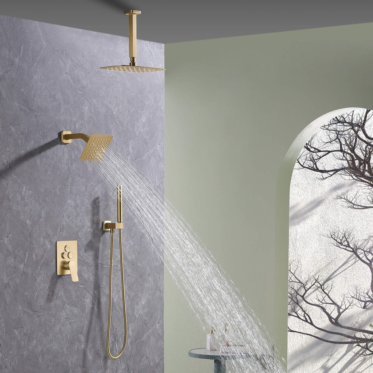 Wall-mounted square shower head with brushed gold finish spraying water as part of dual shower system.