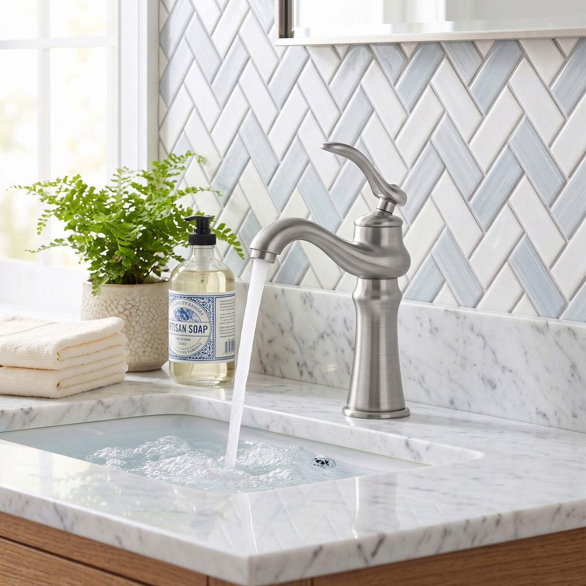 Brushed nickel bathroom faucet installed on a modern marble vanity countertop