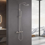 Brushed nickel exposed thermostatic shower system installed in a modern bathroom