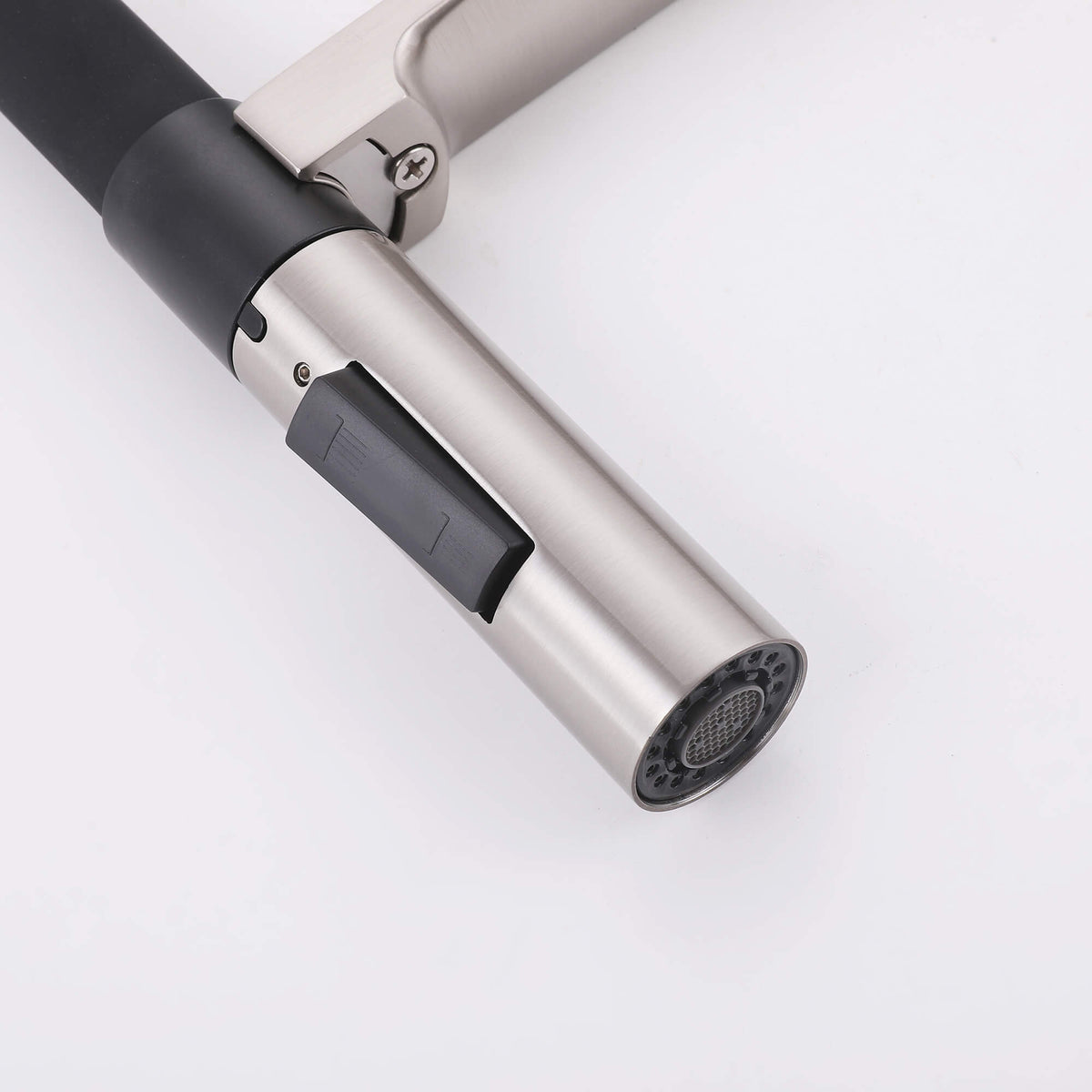 Close-up of brushed nickel pull-down sprayer nozzle with black mode switch