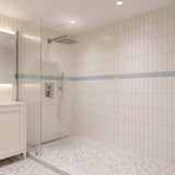 Brushed nickel rainfall shower head providing wide water coverage for a relaxing shower experience