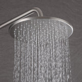 Close-up of brushed nickel round rain shower head with steady rainfall water flow