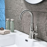 Brushed nickel single handle bathroom sink faucet installed on modern bathroom vanity