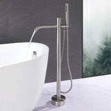 Brushed nickel freestanding tub filler delivering water into a modern bathtub