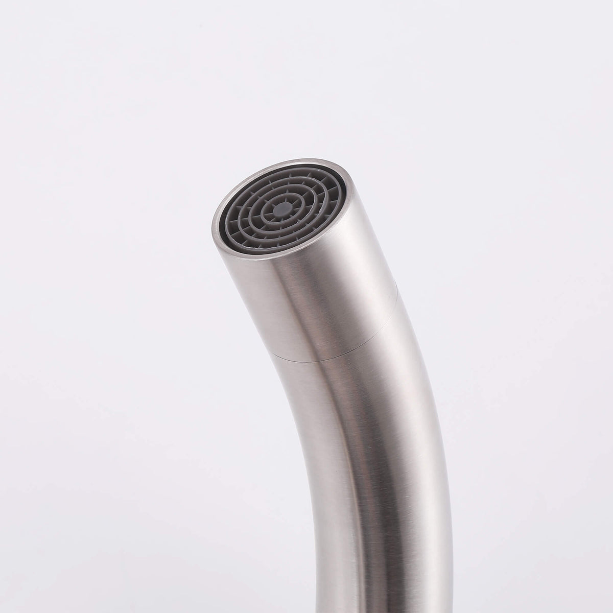 Close-up of brushed nickel floor mount tub filler spout with aerator