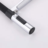 Close-up of chrome pull-down sprayer nozzle with black spray and stream switch