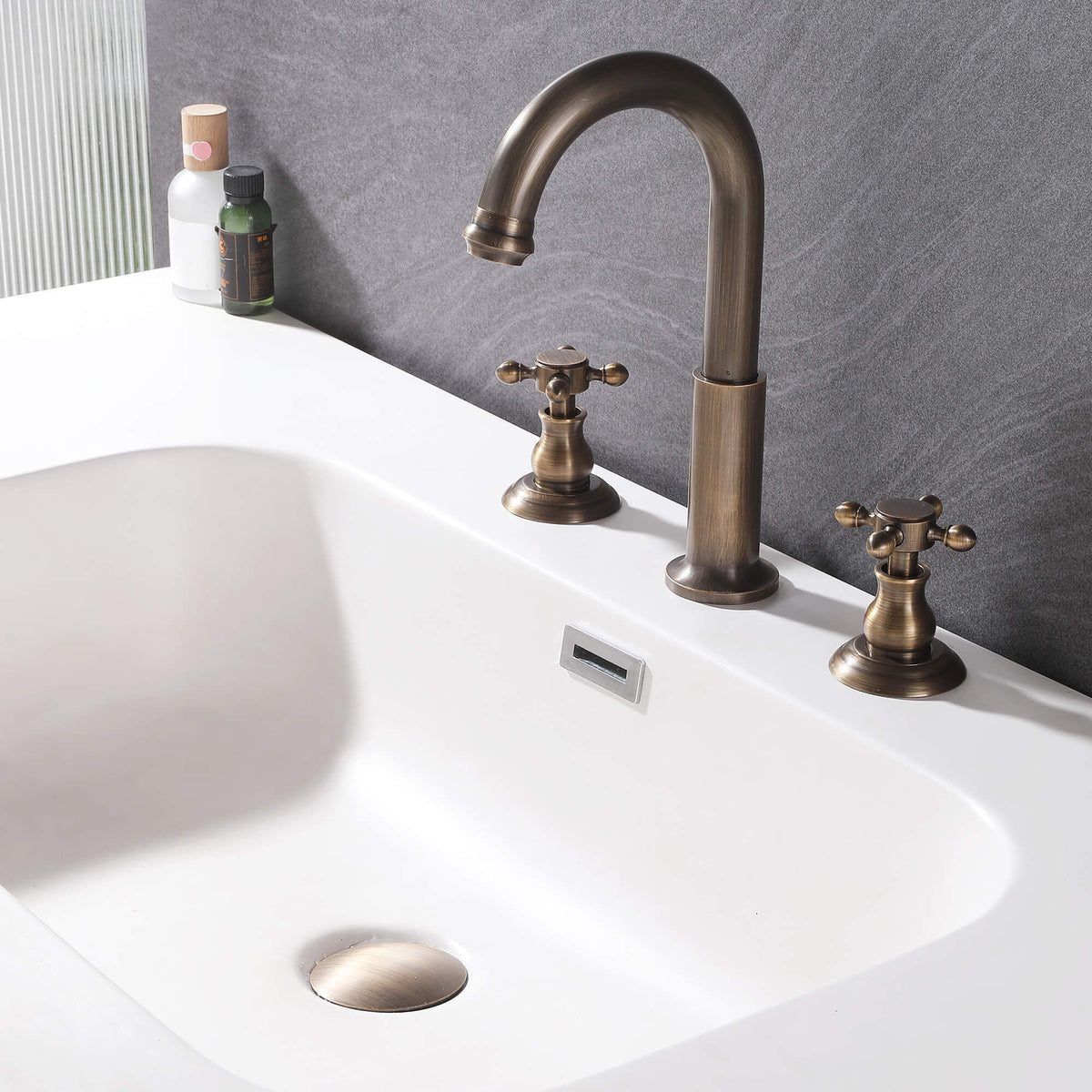 Classic cross handle sink faucet installed on a white bathroom basin