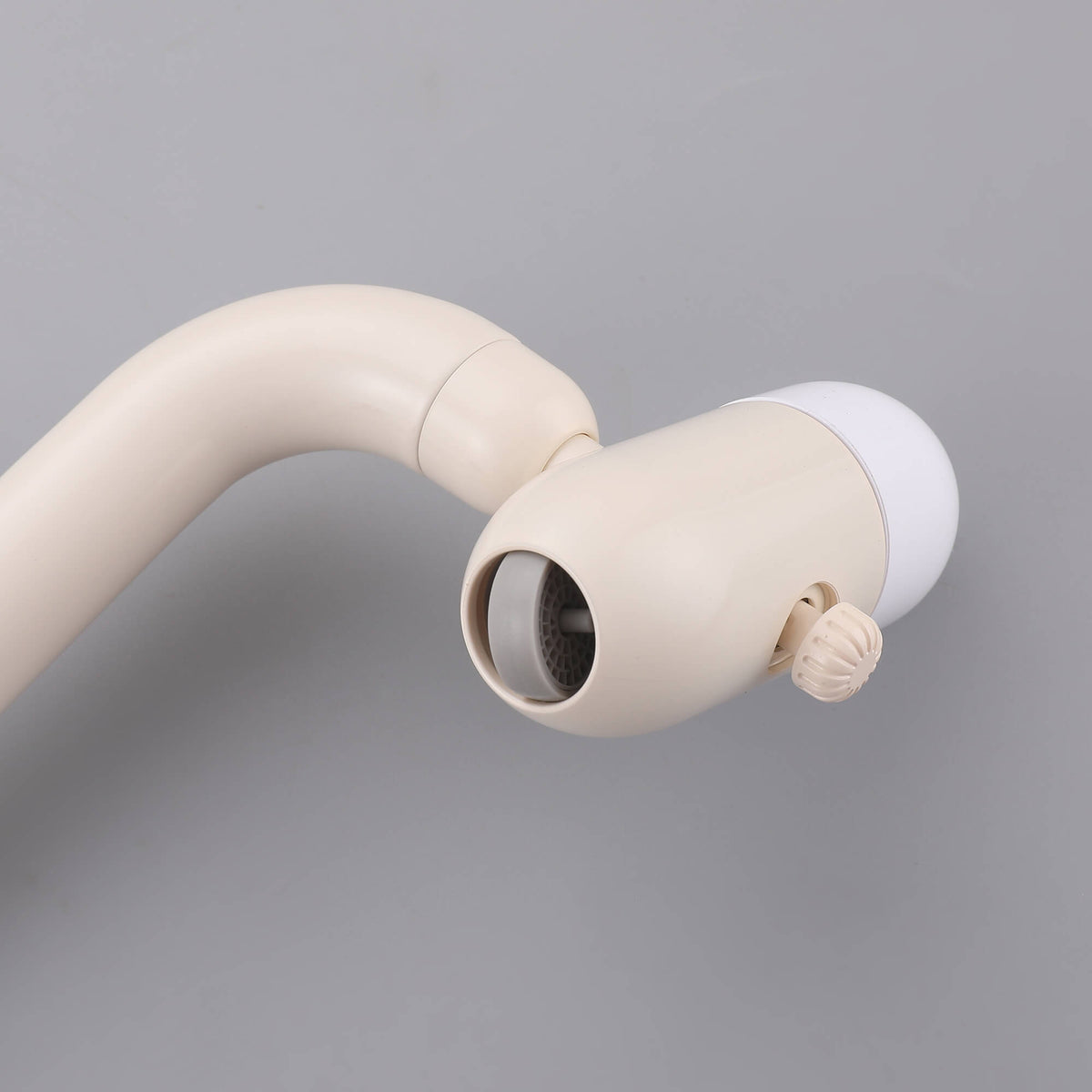 Close-up of cream white faucet aerator and spray nozzle structure