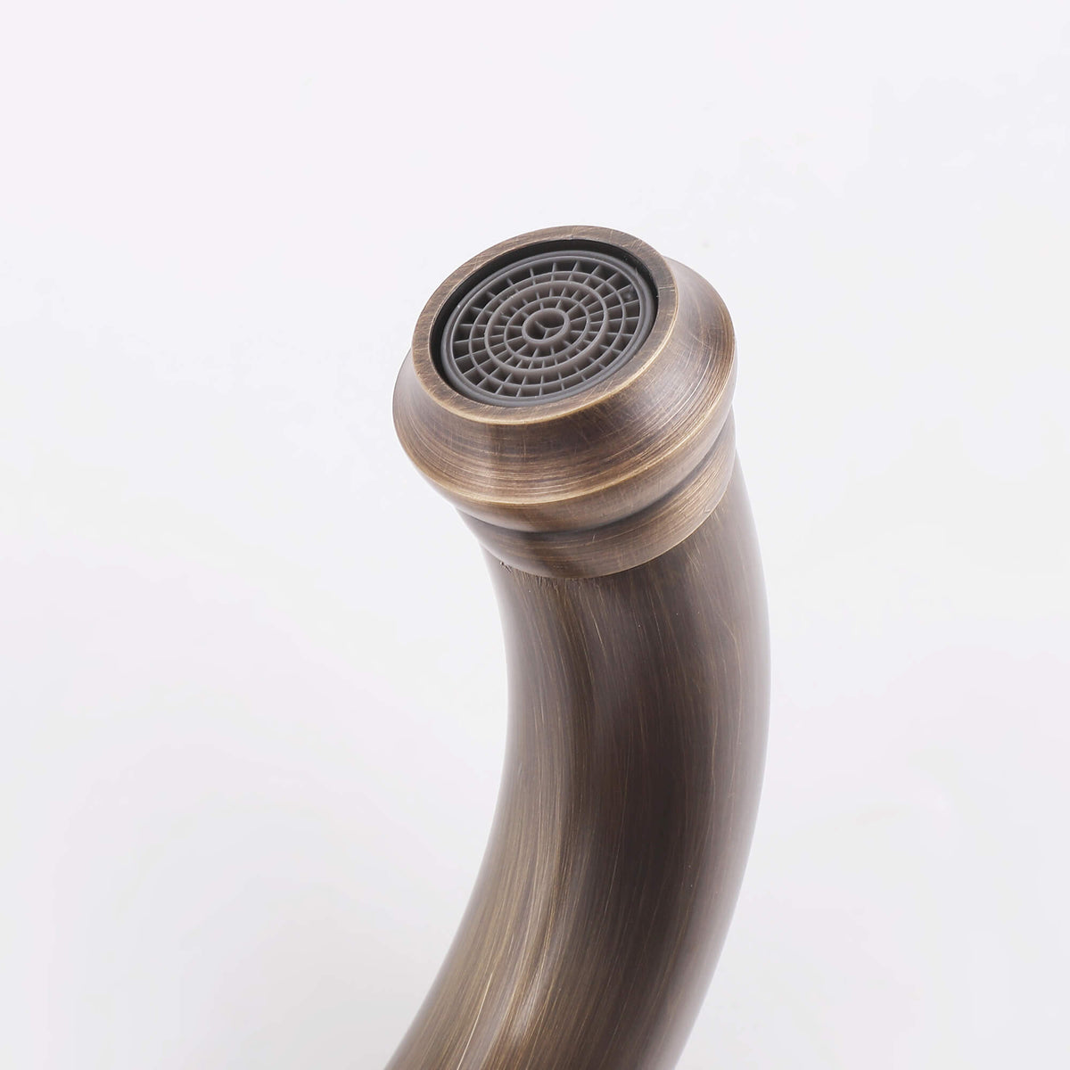 Close-up of the curved bathroom faucet spout and built-in aerator