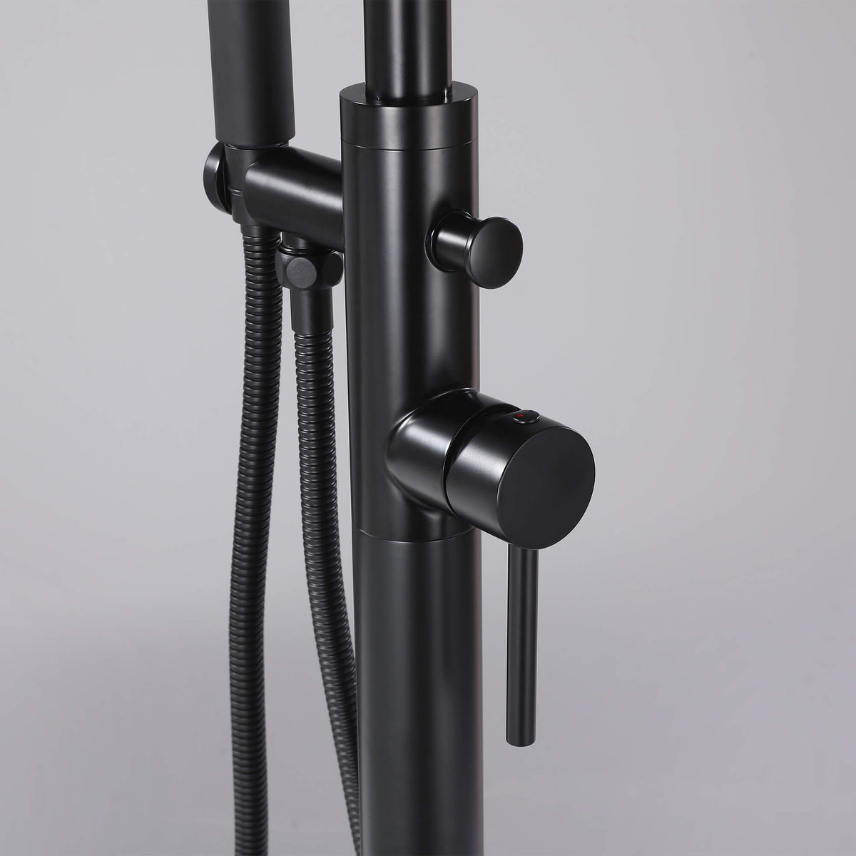 Matte black floor mounted tub filler valve and diverter control with hand shower hose
