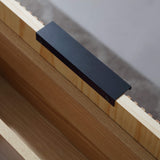 Black drawer handle detail on fluted wood floating bathroom vanity