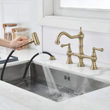 Brushed gold kitchen faucet side sprayer in use for rinsing and sink cleaning