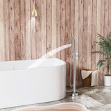 Handheld shower spray on an outdoor freestanding tub faucet beside a bathtub
