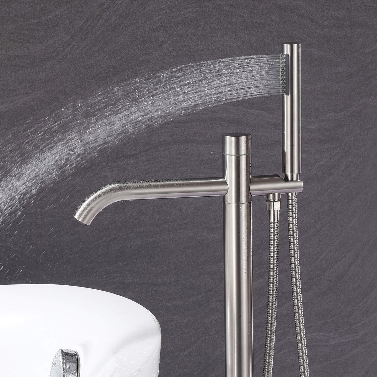 Handheld shower on brushed nickel freestanding tub filler delivering a wide rinsing spray