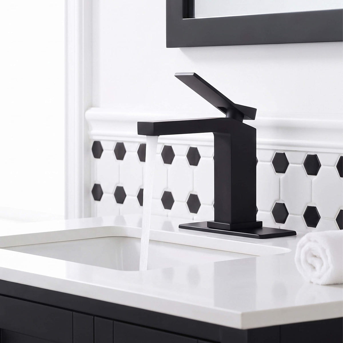 Single handle matte black bathroom faucet showing smooth water flow and modern square spout design