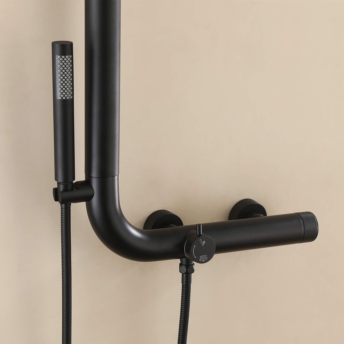 Modern black outdoor shower installed on exterior wall near pool area