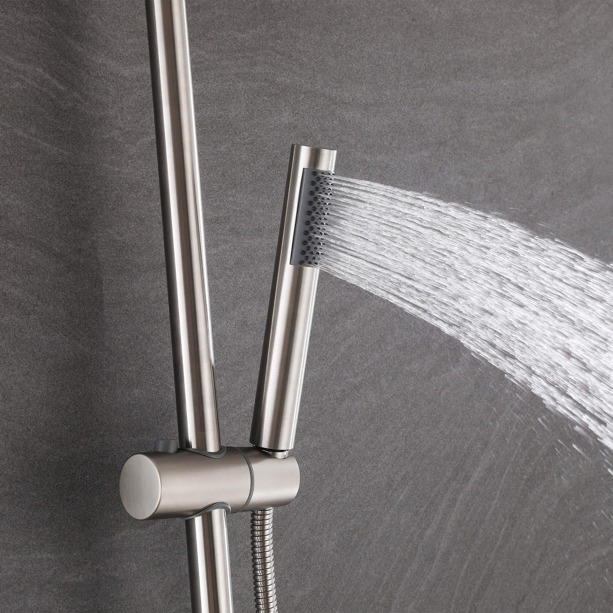 Handheld shower sprayer delivering a wide water spray from the JK0561 brushed nickel outdoor shower system.