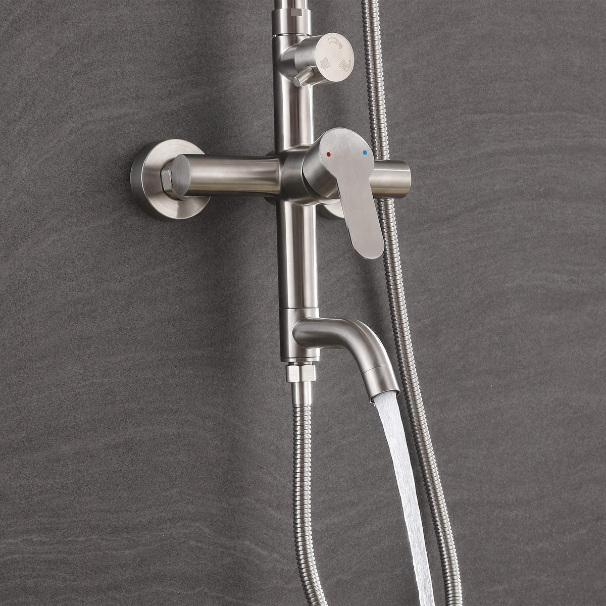 Water flowing from the curved tub spout of the JK0561 brushed nickel outdoor shower system.