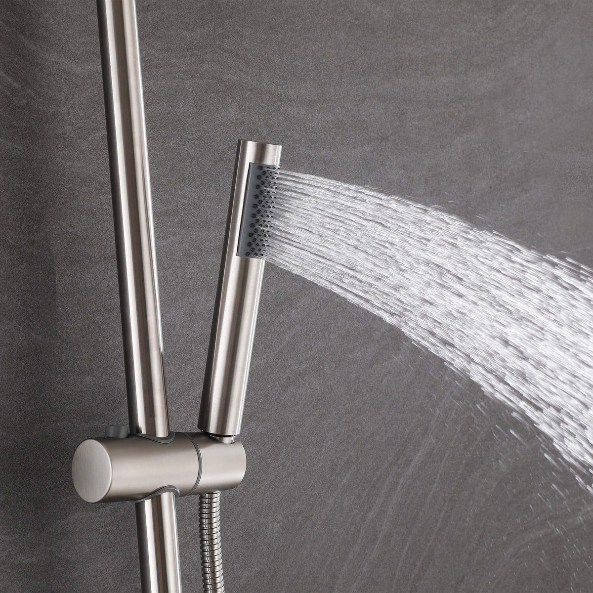 Handheld shower head spraying water from the JK0564 brushed nickel outdoor shower system.