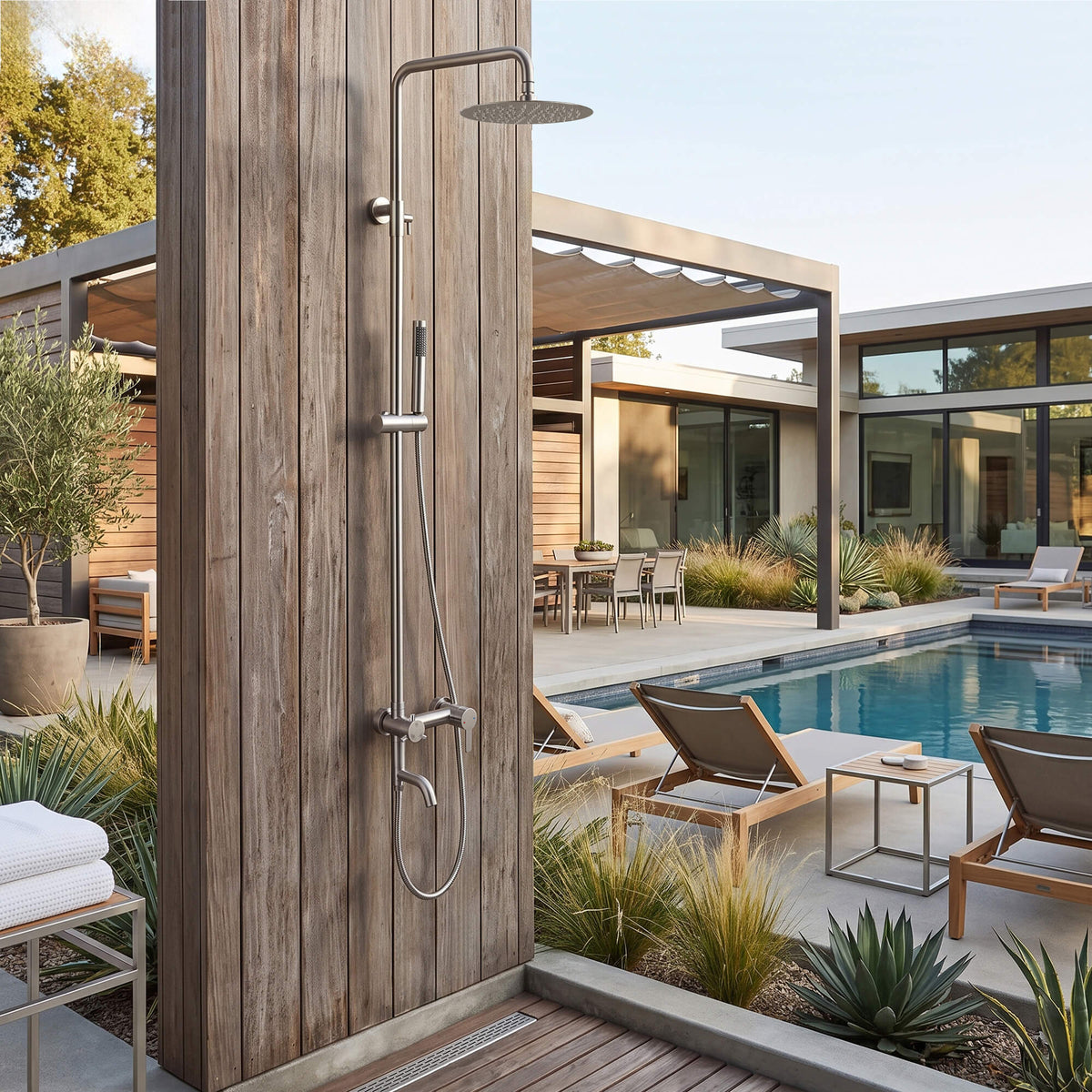 JK0564 brushed nickel wall-mounted outdoor shower installed beside a swimming pool in a modern backyard.