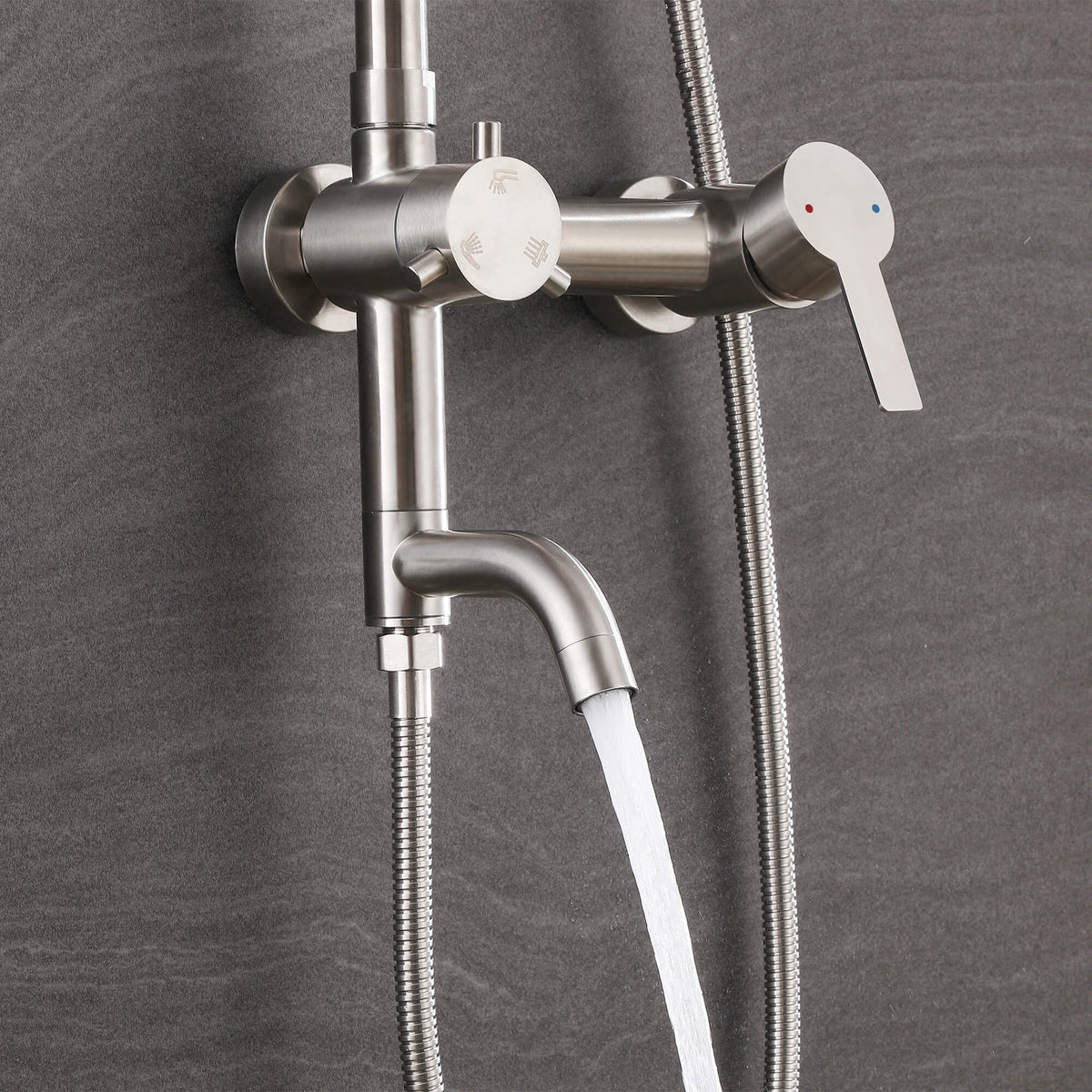 Water flowing from the curved tub spout of the JK0564 brushed nickel wall-mounted outdoor shower system.