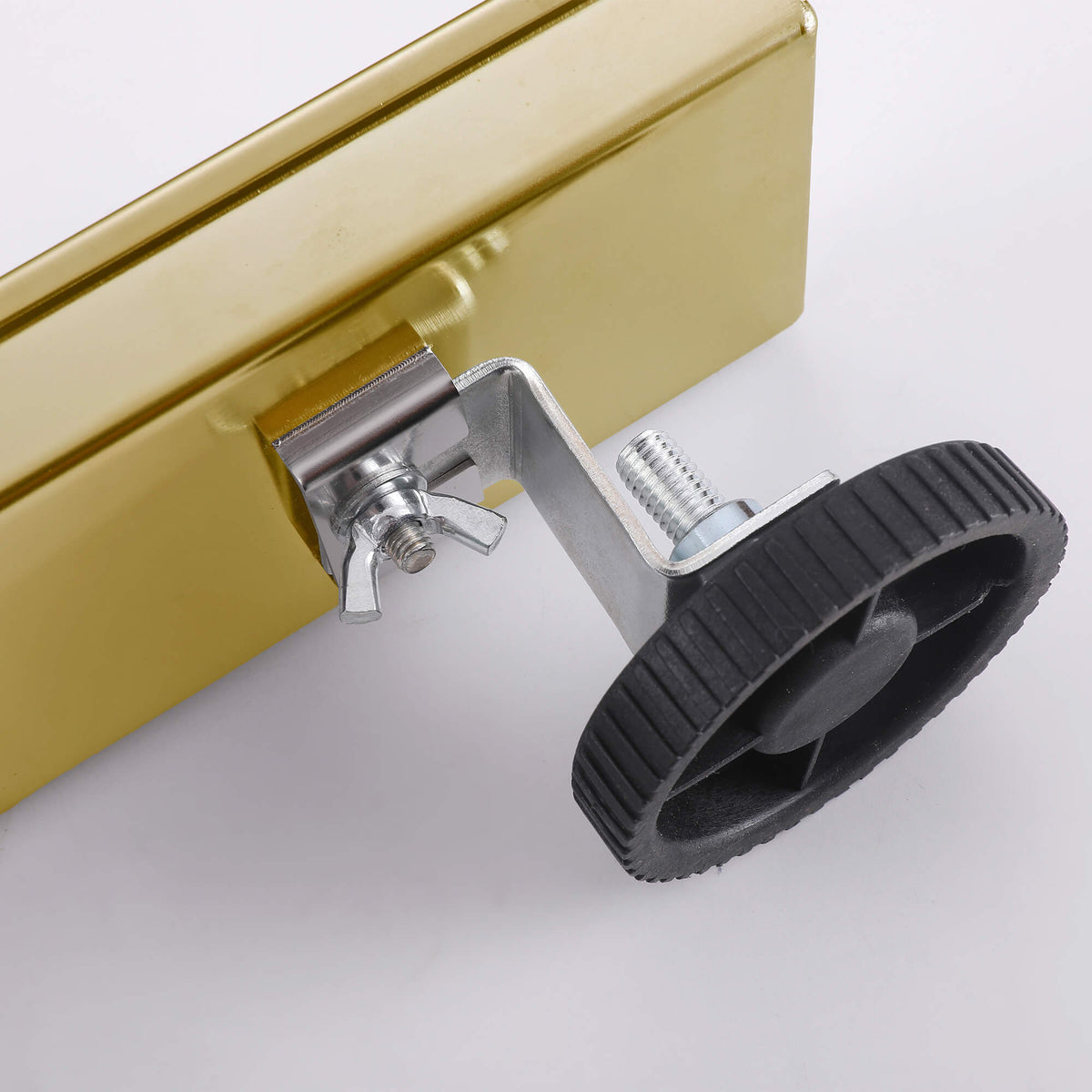 Brushed gold linear shower drain adjustable leveling feet detail
